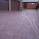 red tarmac drive after looking up to garage doors