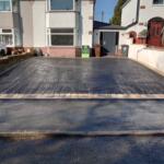 black tarmac drive with with Indian stone setts border