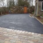 black tarmac drive with indian stone setts