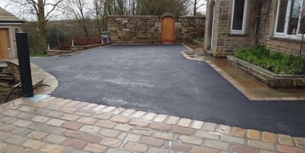black tarmac drive with indian stone setts