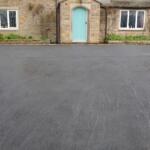 black tarmac drive house